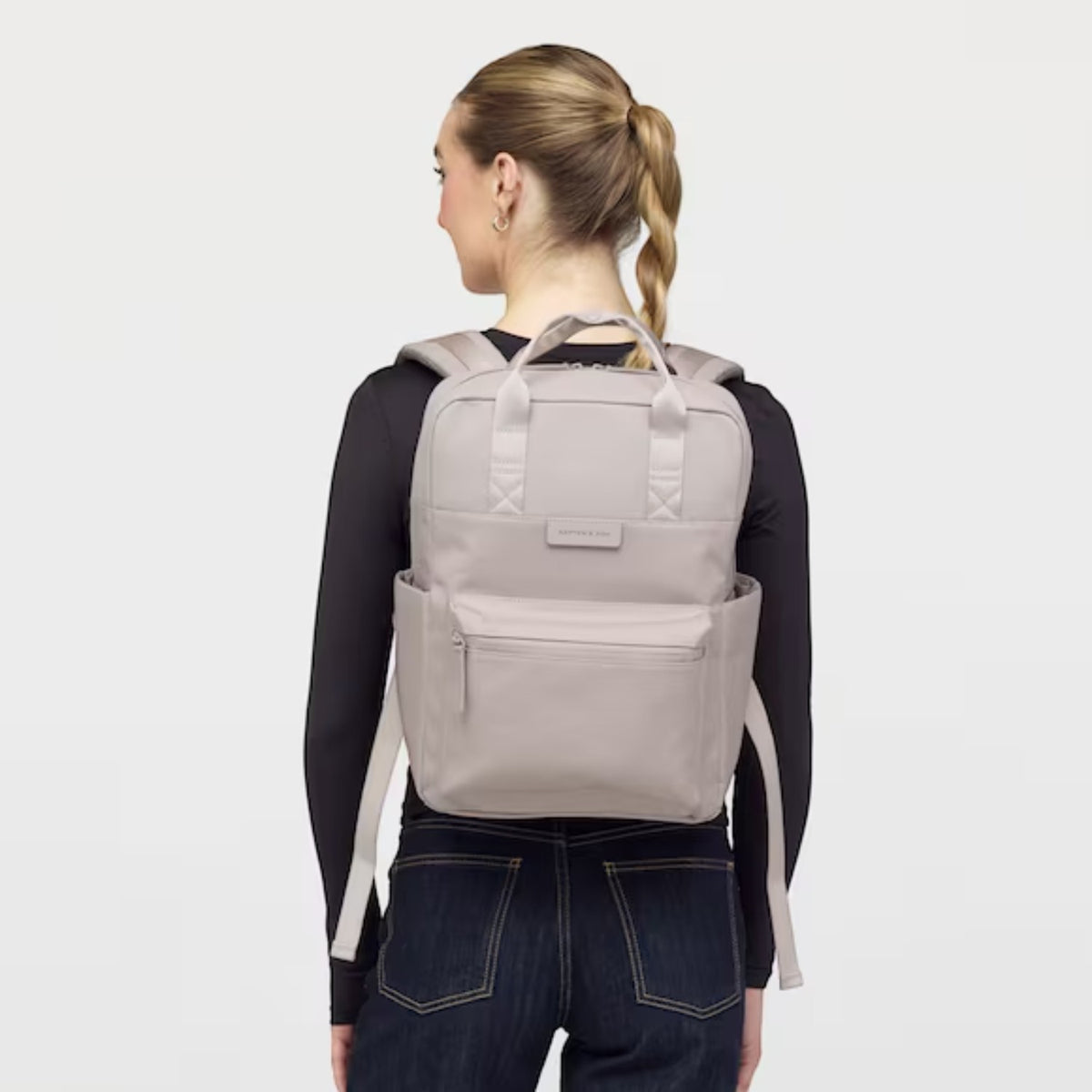 Lieblingstasche Bergen Pro backpack in light taupe worn by a woman against a plain white background