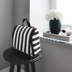 Lieblingstasche Toiletbag XL featuring a black and white striped pattern, displayed on a small black stool.