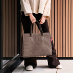 Lieblingstasche Daily Shopper bag in brown teddy fleece material with sturdy handles held by a person