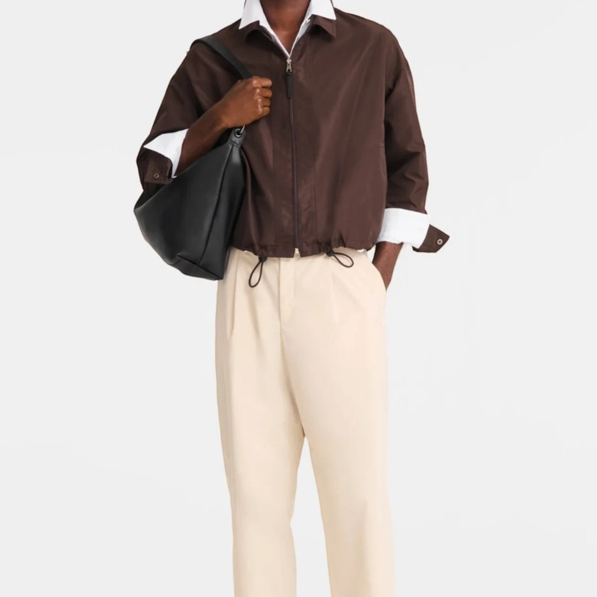 Lieblingstasche Le Pliage Xtra XL shoulder bag in black leather worn by a man in a brown jacket and beige trousers