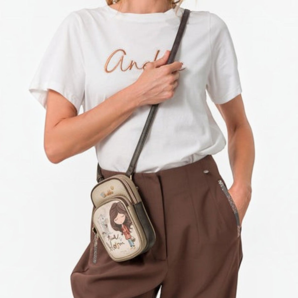 Lieblingstasche mini cross-body bag in beige with a whimsical girl illustration worn by a woman in a white t-shirt