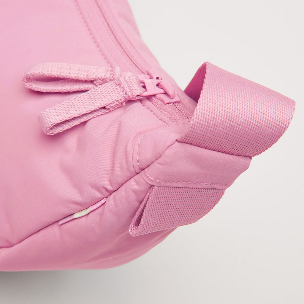 Close-up of the Lieblingstasche Cloud Moon Bag Small in pink, showing the zipper detail and fabric strap.