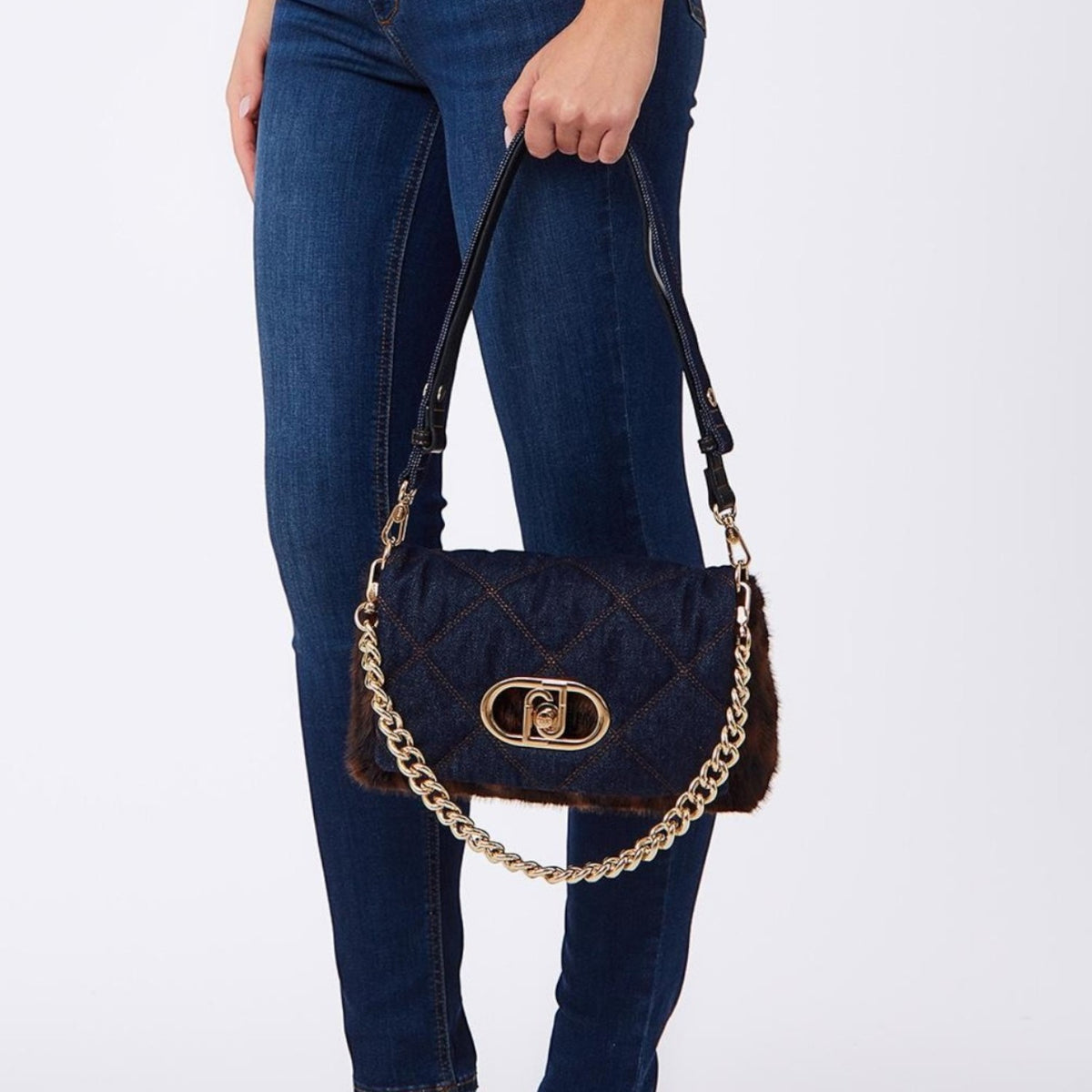 Lieblingstasche Crossbody M bag in quilted denim with brown faux fur trim, gold chain strap, and metal logo clasp.